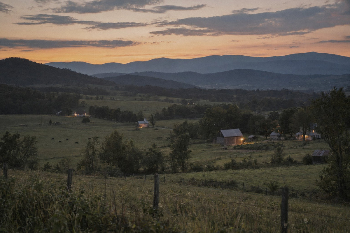 Small homesteads with porch lights on across the Shenandoah Valley at dusk