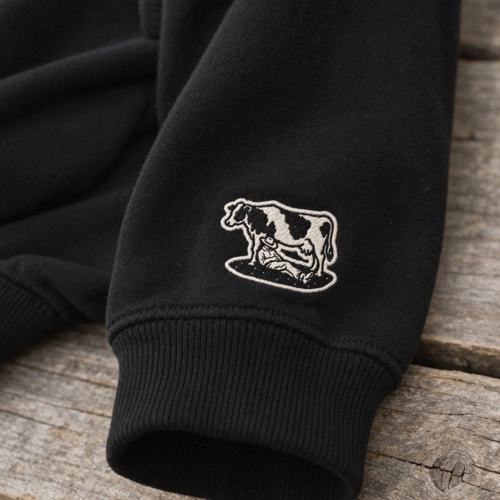 Afternoon Farmer Logo Hoodie in Black, close-up wrist