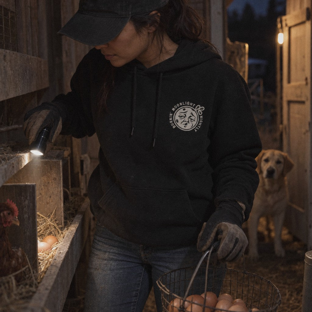 Burnin’ Moonlight Hoodie in Black, checking for eggs by flashlight