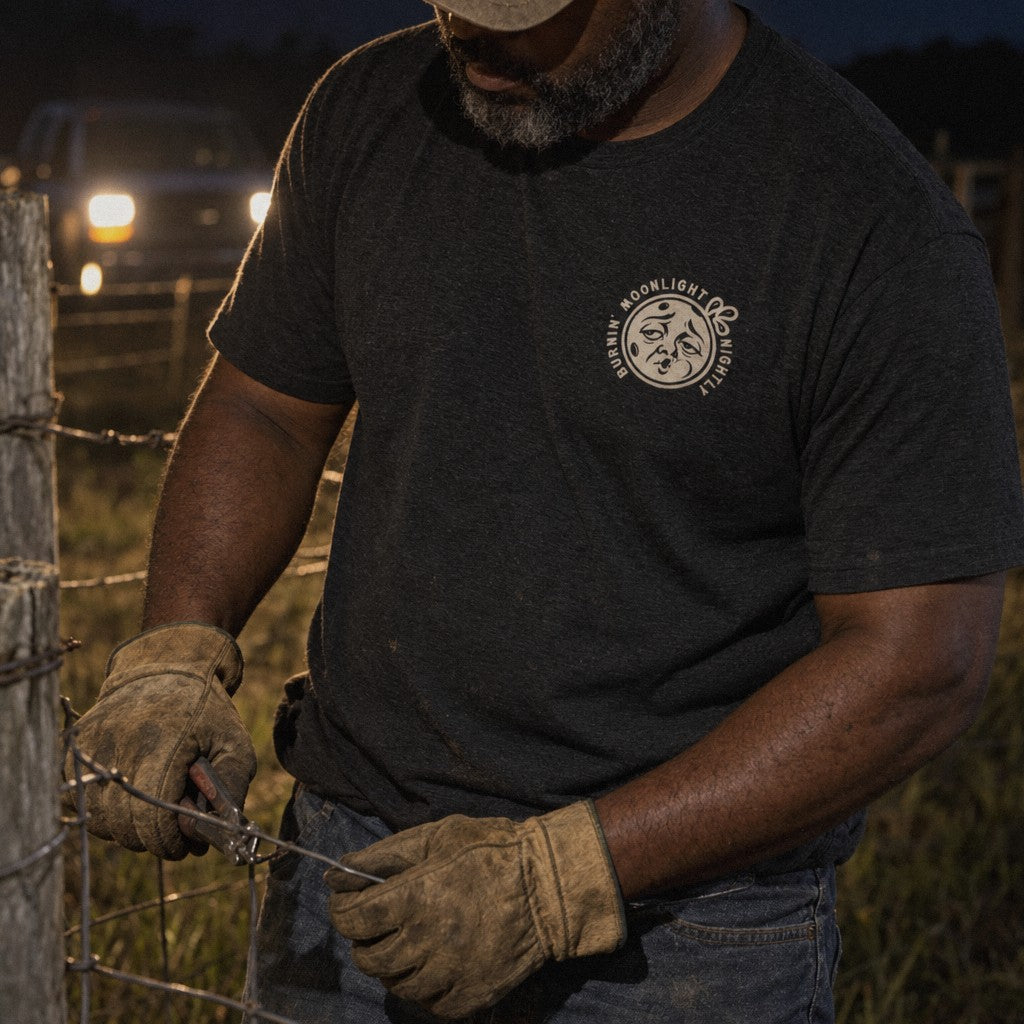 Burnin’ Moonlight Tee in Black Heather, fence by headlights
