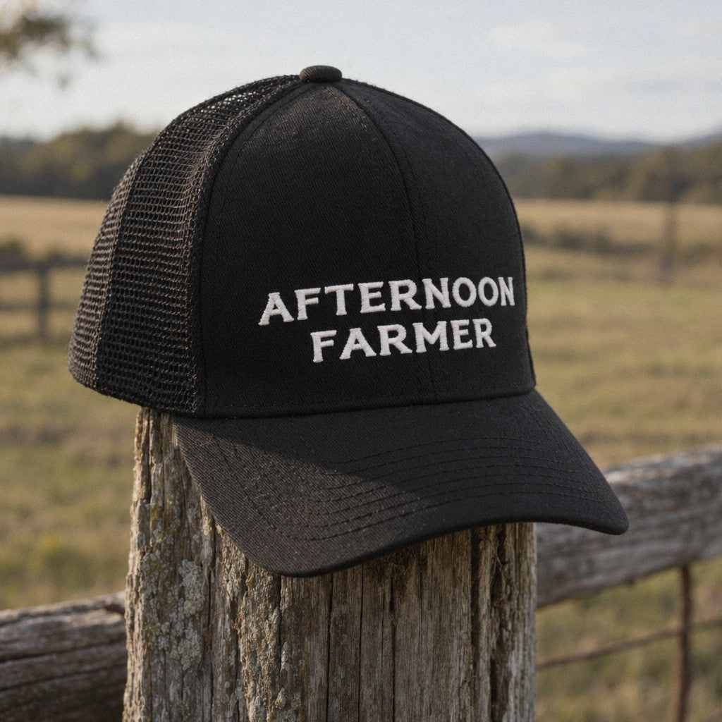 Afternoon Farmer Trucker Hat in Black, close-up hanging