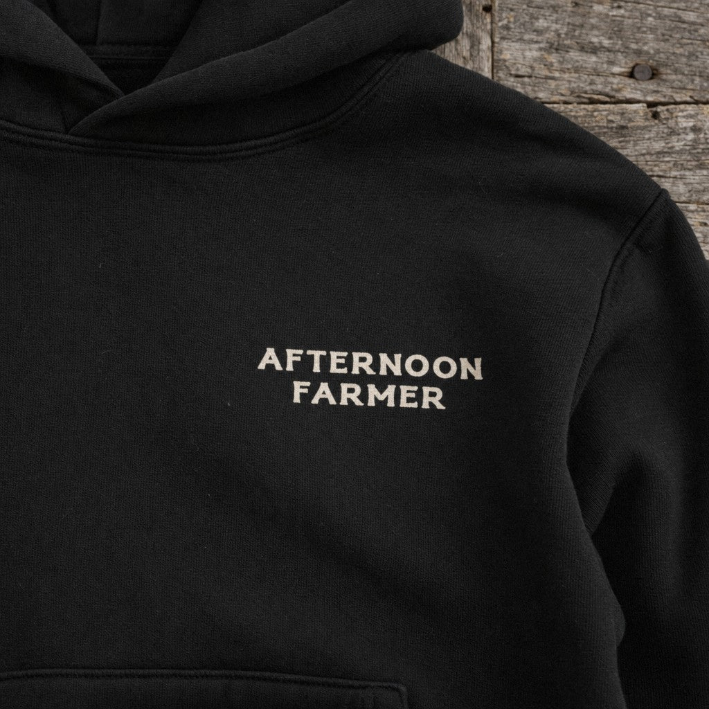 Afternoon Farmer Logo Hoodie in Black, close-up front