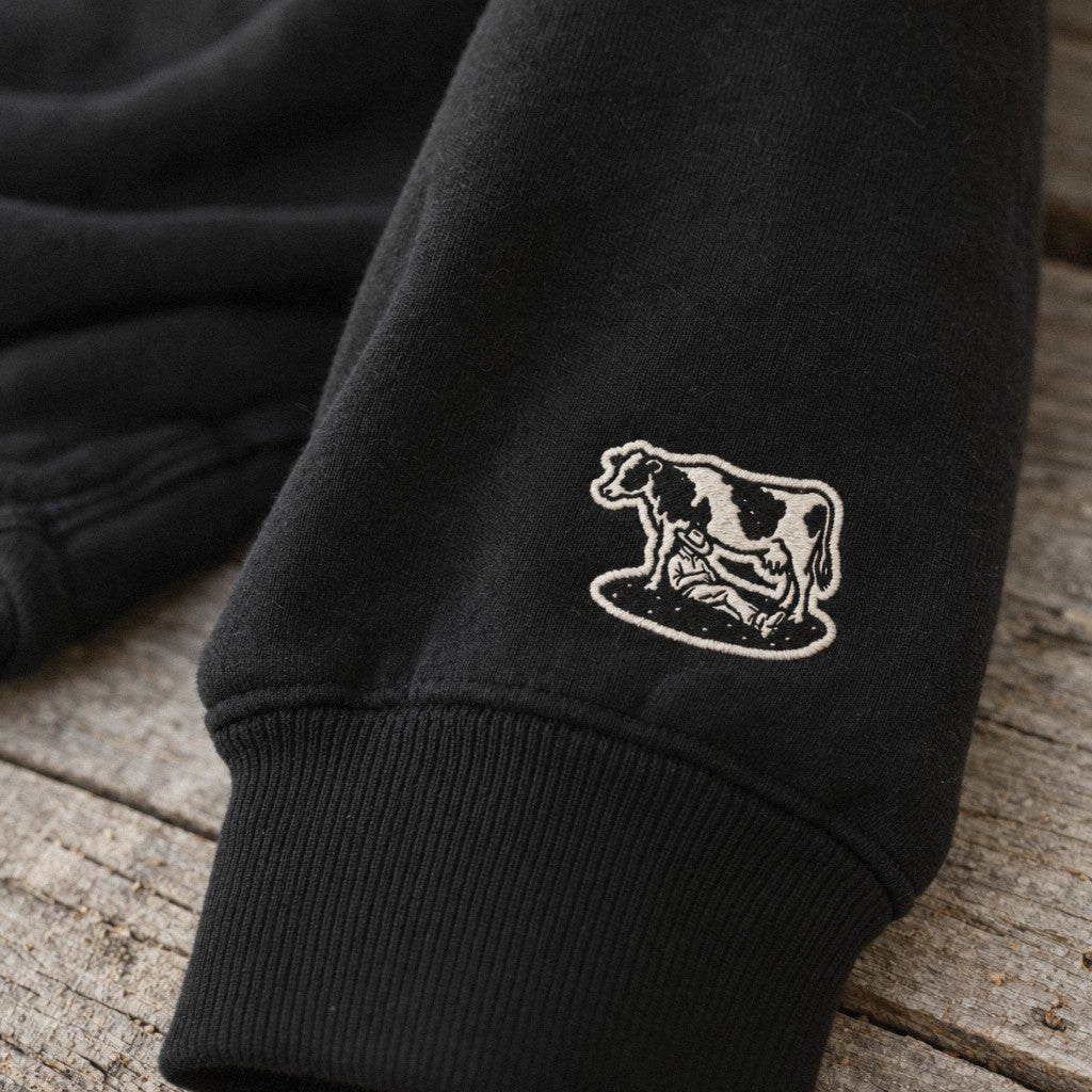 Saturday’s Just Monday in Boots Crewneck in Black, close-up wrist